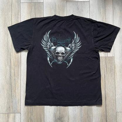 Rock Eagle 2010s Skull Biker Tee is a black T-shirt featuring a large front graphic of a skull-faced biker riding a motorcycle while being chased by a skeletal Grim Reaper holding a scythe. The artwork includes lightning strikes, skulls, and detailed airbrush-style effects throughout the scene. The back features a graphic of a winged engine with a skull at the center. Finished with a Rock Eagle neck tag.
