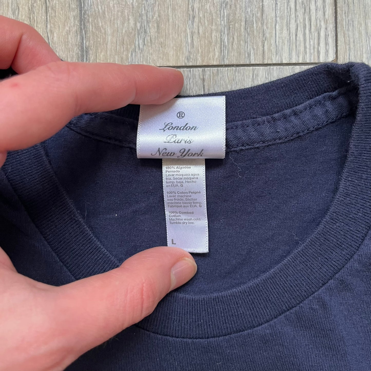 Rockstar Games 'Canis Canem Edit (Bully)' Navy Tee is a dark navy T-shirt made in the USA featuring a yellow "Canis Canem Edit" text on the chest, referencing the original Bully game title. The back displays a large yellow Bullworth Academy logo, while a small yellow Rockstar logo is printed on the sleeve. The shirt includes an official Rockstar Games neck tag.