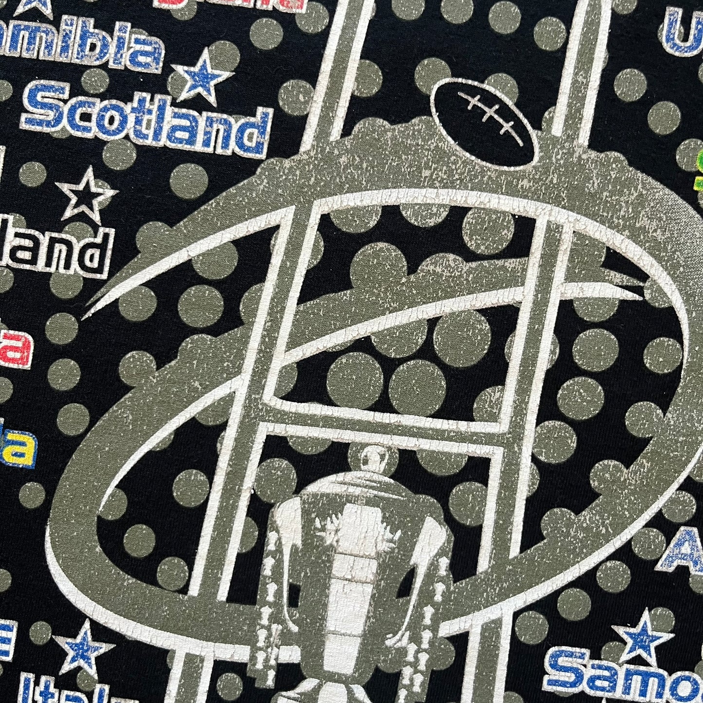 2015 Rugby World Cup tee featuring a front print with a world map, all participating countries, and “2015 World Cup” text. The back displays the date and location of the grand final along with the text “20 teams – only 1 winner.” An official commemorative piece from the 2015 tournament.