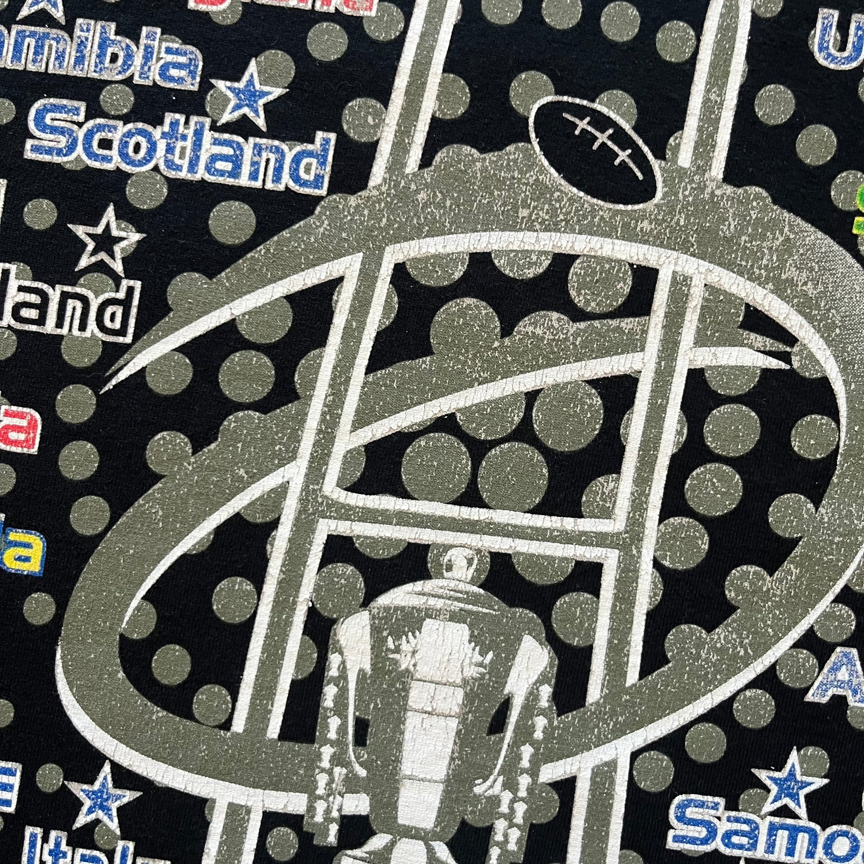 2015 Rugby World Cup tee featuring a front print with a world map, all participating countries, and “2015 World Cup” text. The back displays the date and location of the grand final along with the text “20 teams – only 1 winner.” An official commemorative piece from the 2015 tournament.