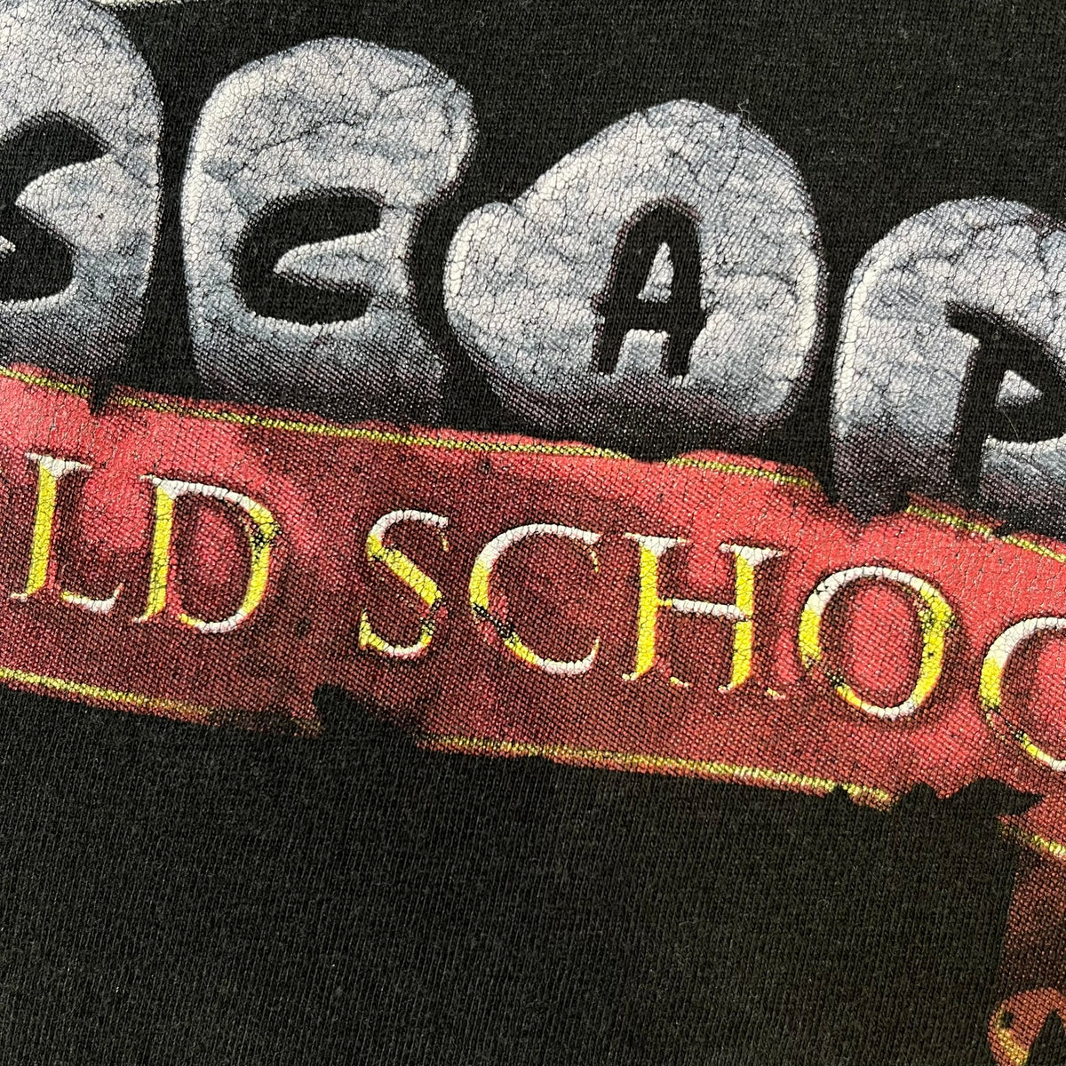 RuneScape Old School 2010's Logo Tee features a black construction with the RuneScape Old School logo printed on the front. The shirt was available through the official Jagex store and dates from the late 2010s to 2020s. Made on a Gildan blank.
