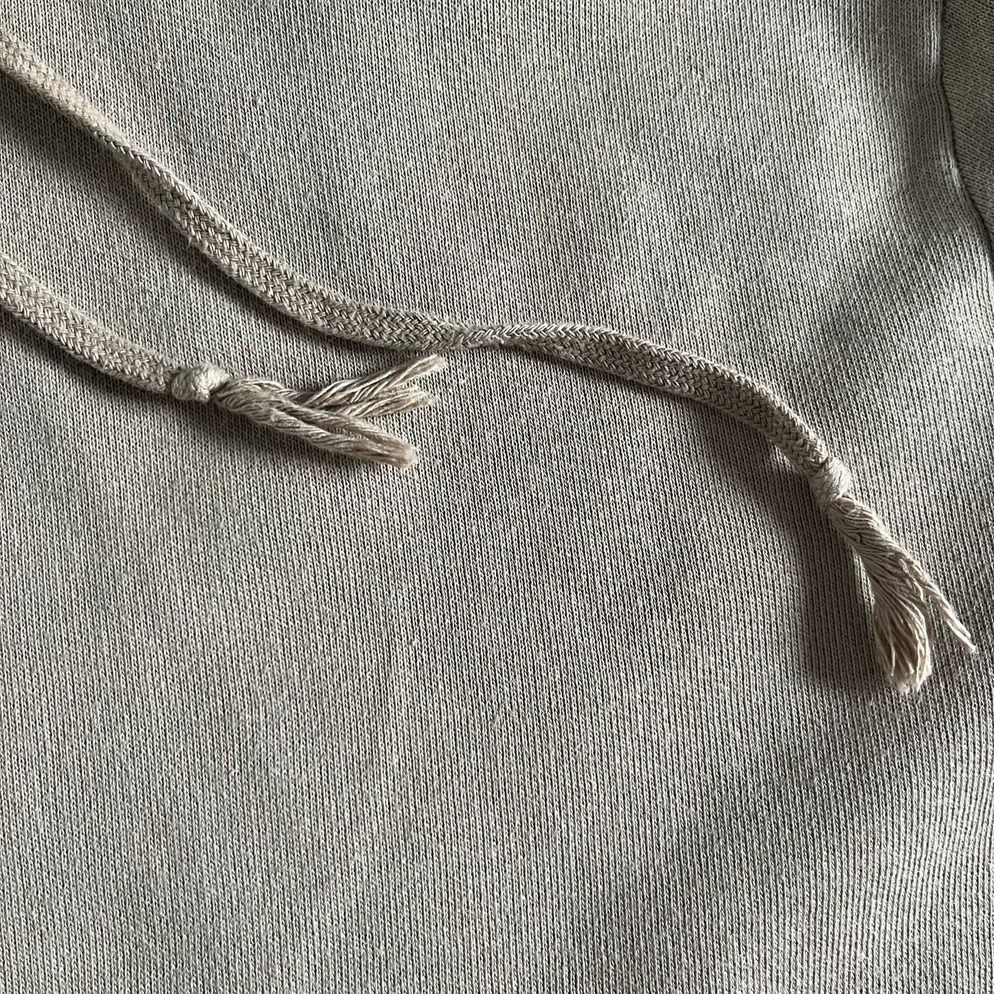 Crafted in France from 100% cotton, this Saint Laurent Beige Hoodie features a minimalist aesthetic with the brand’s signature small Saint Laurent chest logo and red square detail. Designed with a classic front pocket and clean drawstrings without metal tips, it delivers understated Parisian luxury in a neutral tone.