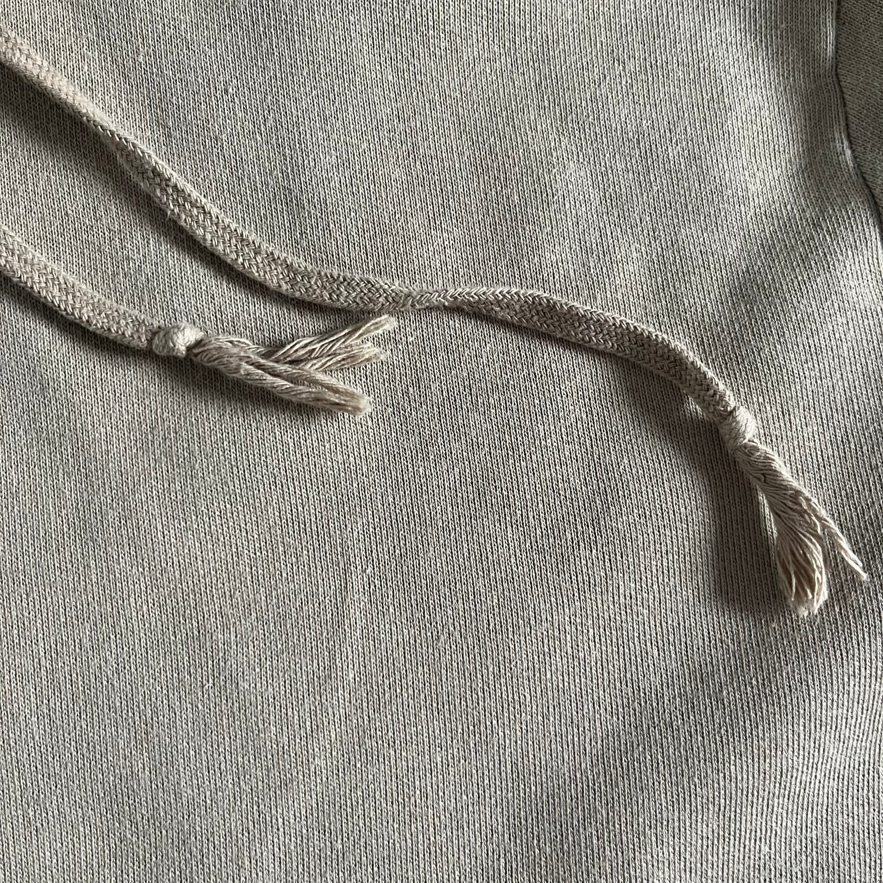 Crafted in France from 100% cotton, this Saint Laurent Beige Hoodie features a minimalist aesthetic with the brand’s signature small Saint Laurent chest logo and red square detail. Designed with a classic front pocket and clean drawstrings without metal tips, it delivers understated Parisian luxury in a neutral tone.