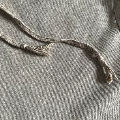 Crafted in France from 100% cotton, this Saint Laurent Beige Hoodie features a minimalist aesthetic with the brand’s signature small Saint Laurent chest logo and red square detail. Designed with a classic front pocket and clean drawstrings without metal tips, it delivers understated Parisian luxury in a neutral tone.