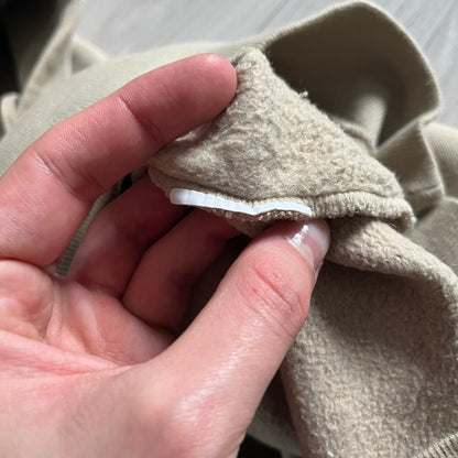 Crafted in France from 100% cotton, this Saint Laurent Beige Hoodie features a minimalist aesthetic with the brand’s signature small Saint Laurent chest logo and red square detail. Designed with a classic front pocket and clean drawstrings without metal tips, it delivers understated Parisian luxury in a neutral tone.