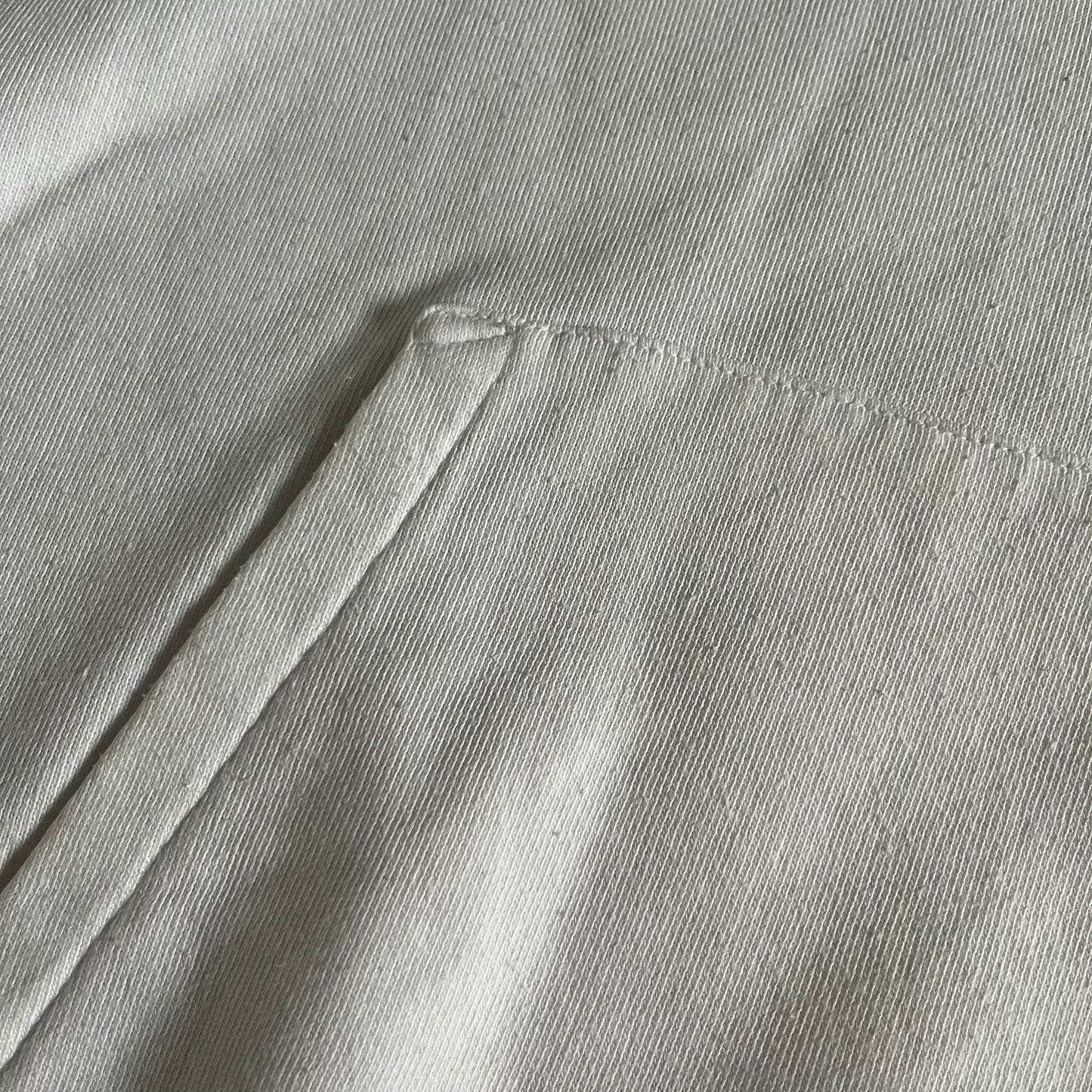 Saint Laurent Small Logo White Hoodie made in France from 100% cotton. Features a minimalist chest logo with “Saint” and “Laurent” separated by a small red square, silver-tipped drawstrings engraved with branding, and a classic front pocket. Designed with the brand’s signature minimalist aesthetic.