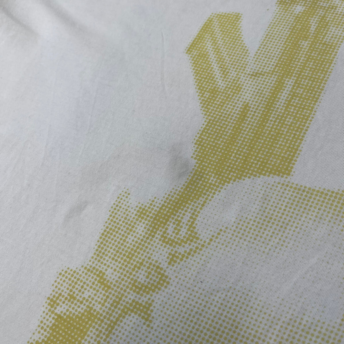 Saints Row 2 x PLNY Textylia 2008 White Promo Tee is a rare Poland-exclusive promotional shirt released for Saints Row 2 in collaboration with Polish brand PLNY Textylia, limited to a numbered run (this piece numbered #00059). The front features a black and white Saints Row 2 logo over yellow tribal graphics with a smaller PLNY Textylia logo below, plus a patch displaying both brand logos, while the back carries a large yellow dot/square-style graphic of the game's cover character.