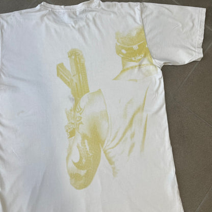 Saints Row 2 x PLNY Textylia 2008 White Promo Tee is a rare Poland-exclusive promotional shirt released for Saints Row 2 in collaboration with Polish brand PLNY Textylia, limited to a numbered run (this piece numbered #00059). The front features a black and white Saints Row 2 logo over yellow tribal graphics with a smaller PLNY Textylia logo below, plus a patch displaying both brand logos, while the back carries a large yellow dot/square-style graphic of the game's cover character.