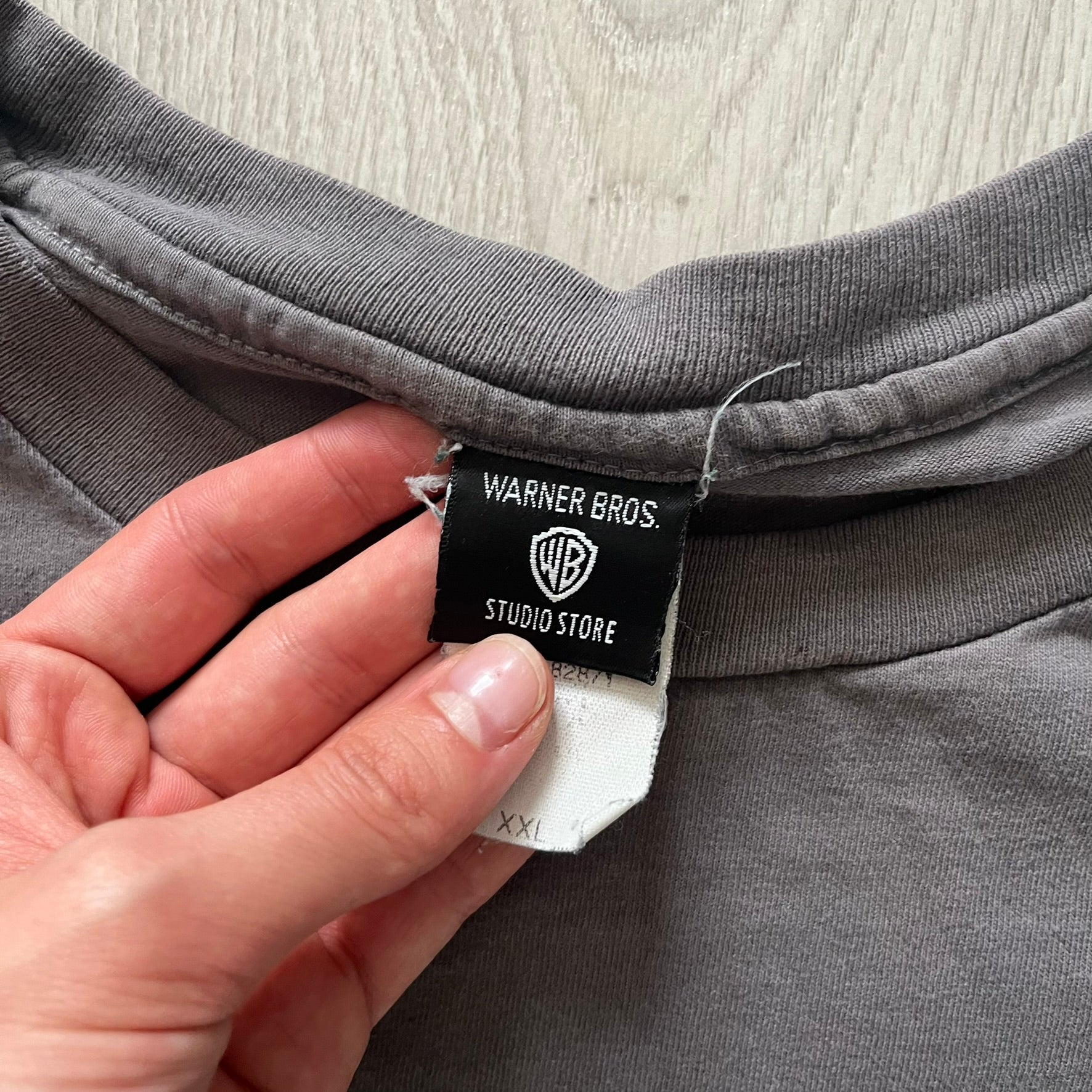 Gray Scooby-Doo tee from 1998, officially licensed by Warner Bros. Studio Store. Graphic shows Scooby emerging through the shirt as if he tore it, paired with classic text. Single-stitch USA-made construction adds authentic vintage charm.