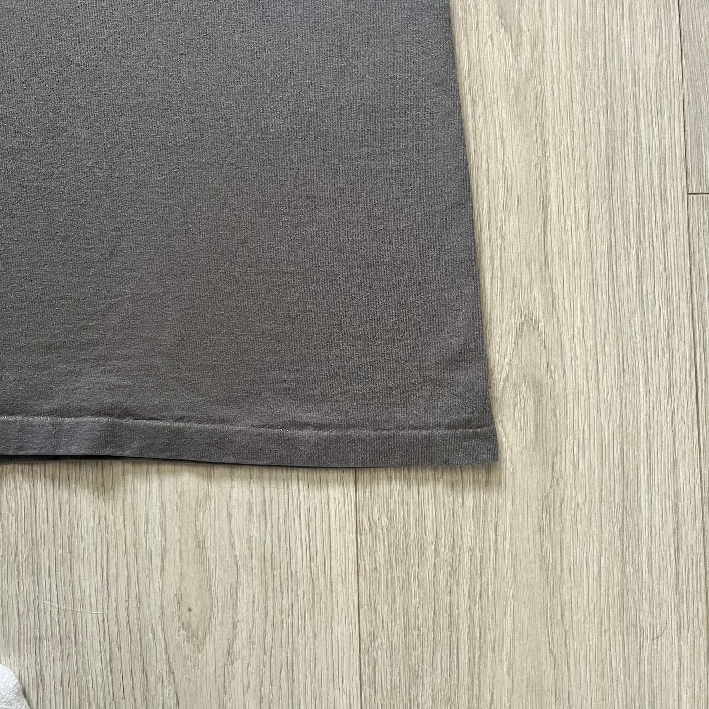 Gray Scooby-Doo tee from 1998, officially licensed by Warner Bros. Studio Store. Graphic shows Scooby emerging through the shirt as if he tore it, paired with classic text. Single-stitch USA-made construction adds authentic vintage charm.