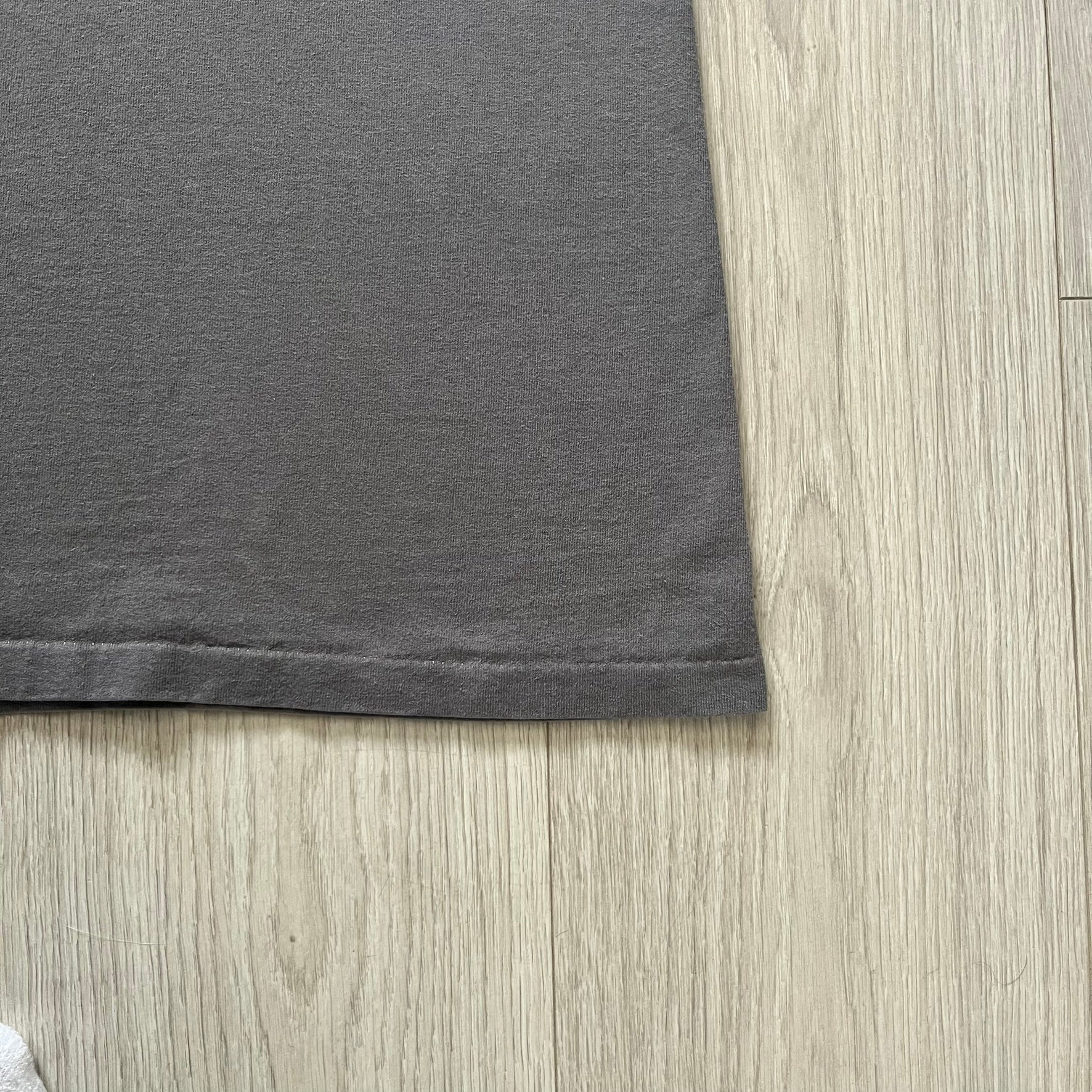 Gray Scooby-Doo tee from 1998, officially licensed by Warner Bros. Studio Store. Graphic shows Scooby emerging through the shirt as if he tore it, paired with classic text. Single-stitch USA-made construction adds authentic vintage charm.