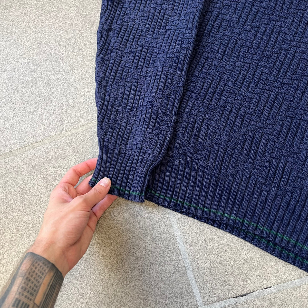 Sedgefield 1990's Basketweave Navy Sweater is a heavyweight navy sweater made in the USA, featuring a thin green line detail on the collar.