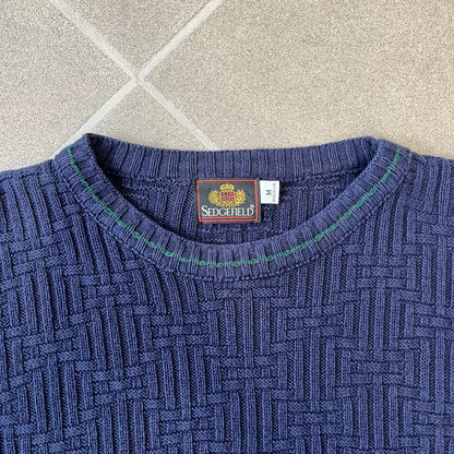 Sedgefield 1990's Basketweave Navy Sweater is a heavyweight navy sweater made in the USA, featuring a thin green line detail on the collar.