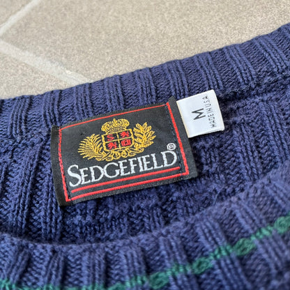 Sedgefield 1990's Basketweave Navy Sweater is a heavyweight navy sweater made in the USA, featuring a thin green line detail on the collar.