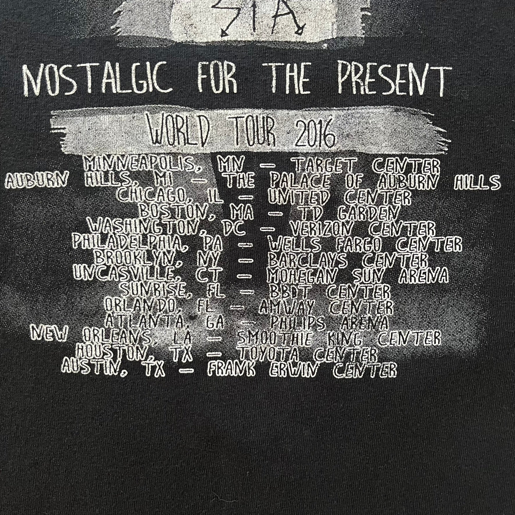 Sia 2016 Nostalgic For The Present tour tee in black, printed on a durable Delta Pro Weight blank. The front features a Sia graphic, while the back lists all U.S. tour cities where she performed. Made as official merchandise for the 2016 tour, this tee combines quality construction with collectible tour details.