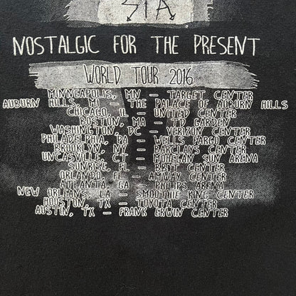  Sia 2016 Nostalgic For The Present tour tee in black, printed on a durable Delta Pro Weight blank. The front features a Sia graphic, while the back lists all U.S. tour cities where she performed. Made as official merchandise for the 2016 tour, this tee combines quality construction with collectible tour details.