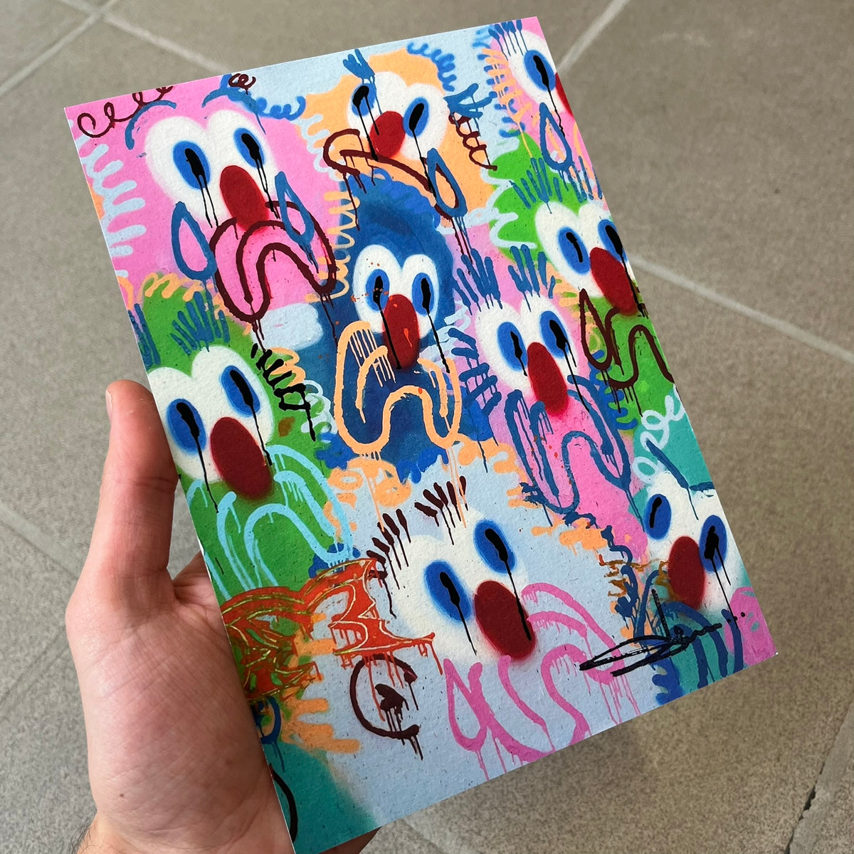 Slawn 2026 Scary Sights Print is a high-quality A5 print of Slawn's "Scary Sights" painting, featuring multiple colorful sad faces with Slawn's signature in the bottom right. The print was produced for the Rolex event tied to the Playboi Carti watch.
