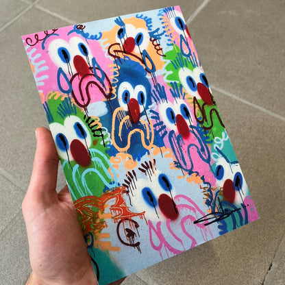 Slawn 2026 Scary Sights Print is a high-quality A5 print of Slawn's "Scary Sights" painting, featuring multiple colorful sad faces with Slawn's signature in the bottom right. The print was produced for the Rolex event tied to the Playboi Carti watch.