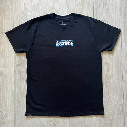  Black Batpreme tee designed by Slawn with Supreme Box Logo and his iconic Batman graphic on the front. Printed neck tag with signature and back shows handwritten-style text saying “This really isn’t real Supreme” with Slawn signature and the Supreme bogo. A rare, art-driven streetwear essential.