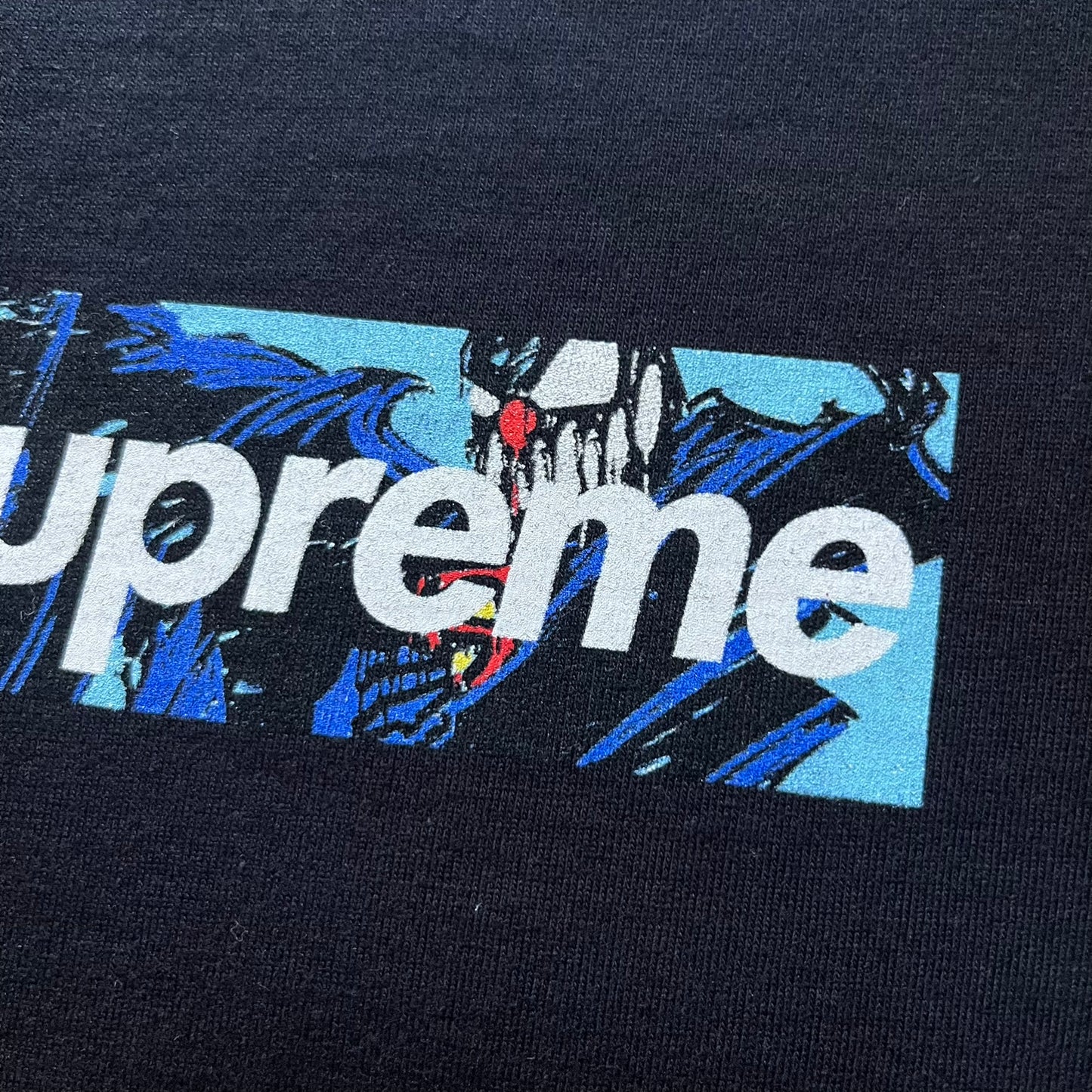 Black Batpreme tee designed by Slawn with Supreme Box Logo and his iconic Batman graphic on the front. Printed neck tag with signature and back shows handwritten-style text saying “This really isn’t real Supreme” with Slawn signature and the Supreme bogo. A rare, art-driven streetwear essential.