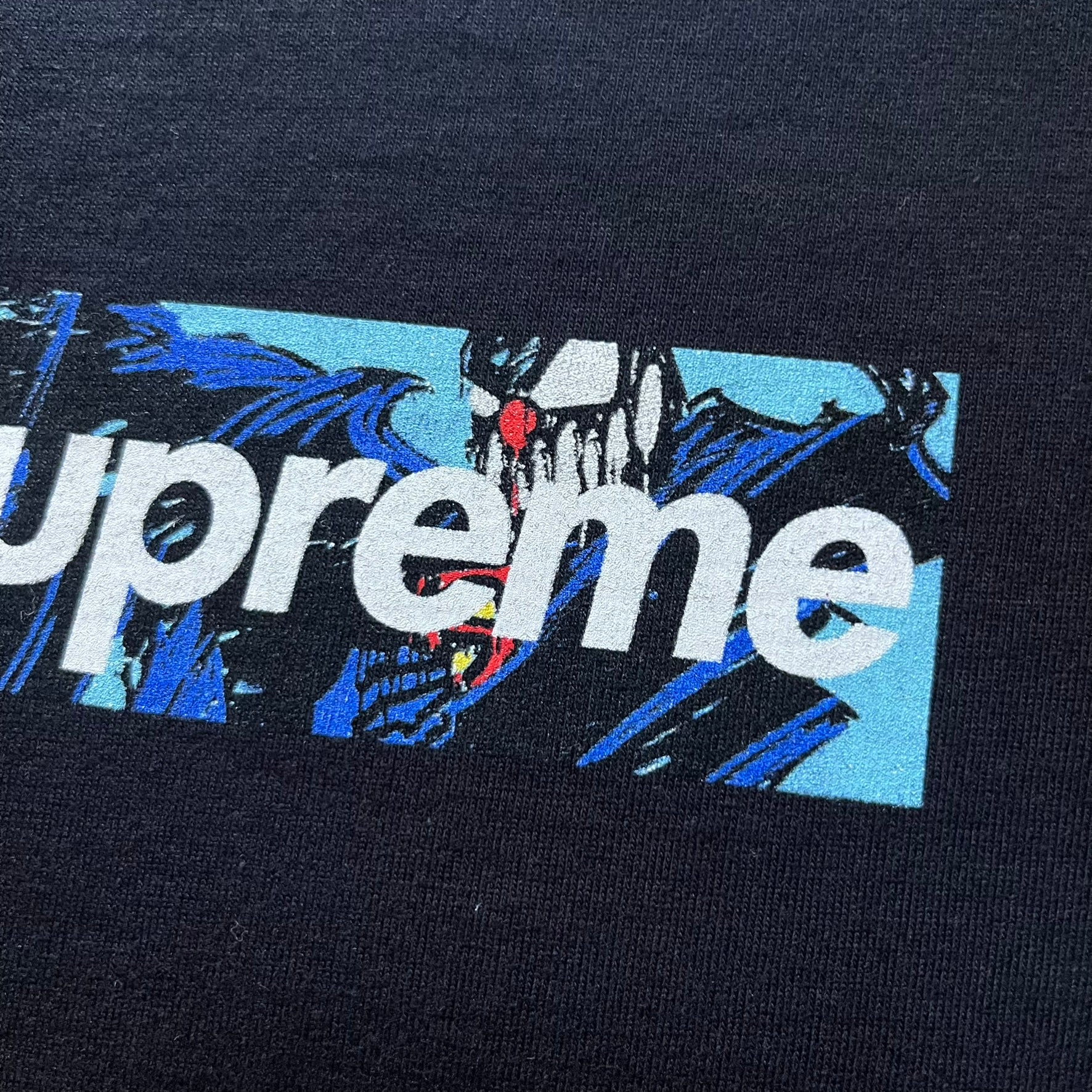 Black Batpreme tee designed by Slawn with Supreme Box Logo and his iconic Batman graphic on the front. Printed neck tag with signature and back shows handwritten-style text saying “This really isn’t real Supreme” with Slawn signature and the Supreme bogo. A rare, art-driven streetwear essential.