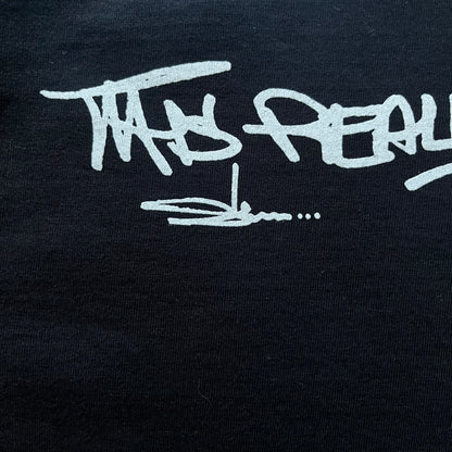 Black Batpreme tee designed by Slawn with Supreme Box Logo and his iconic Batman graphic on the front. Printed neck tag with signature and back shows handwritten-style text saying “This really isn’t real Supreme” with Slawn signature and the Supreme bogo. A rare, art-driven streetwear essential.