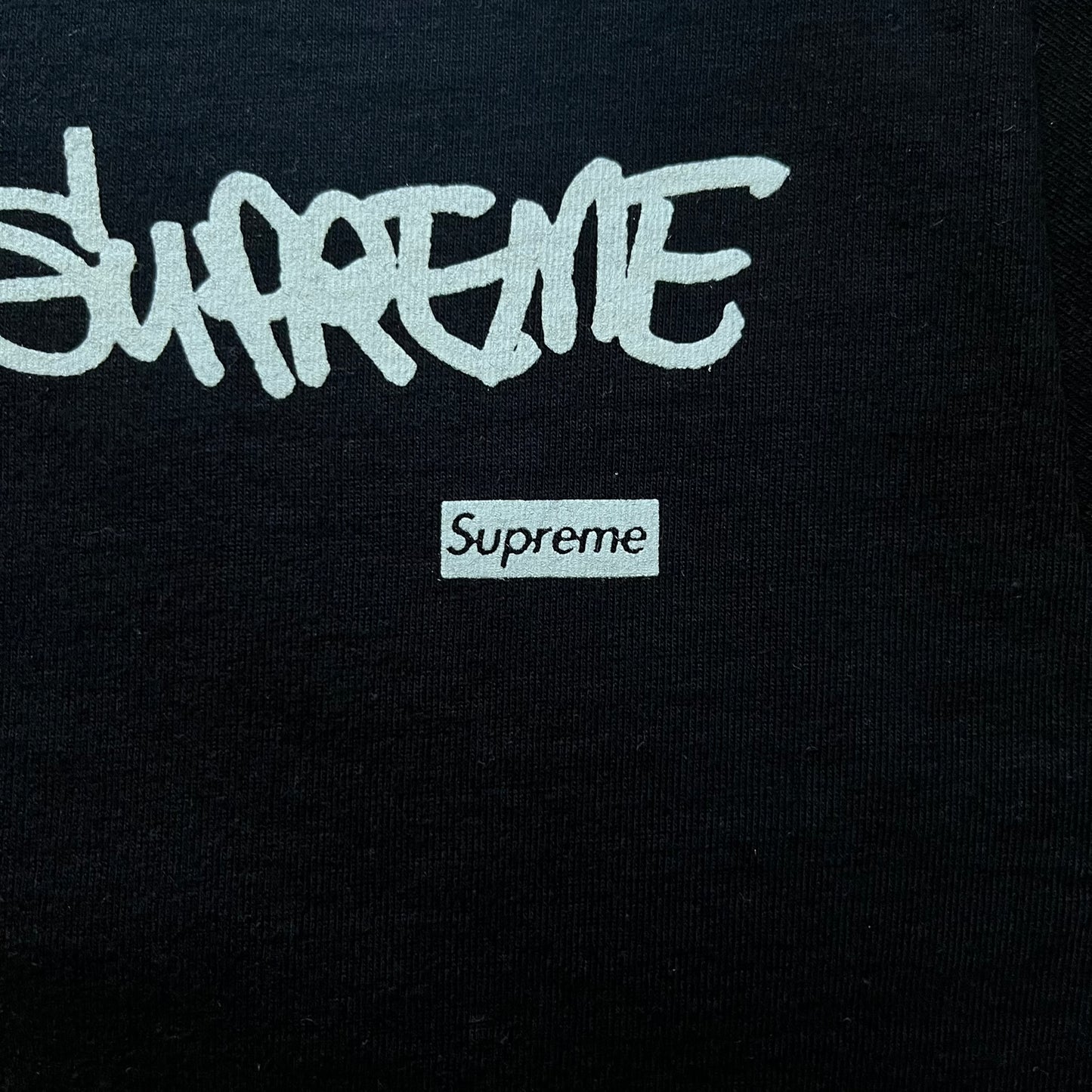 Black Batpreme tee designed by Slawn with Supreme Box Logo and his iconic Batman graphic on the front. Printed neck tag with signature and back shows handwritten-style text saying “This really isn’t real Supreme” with Slawn signature and the Supreme bogo. A rare, art-driven streetwear essential.
