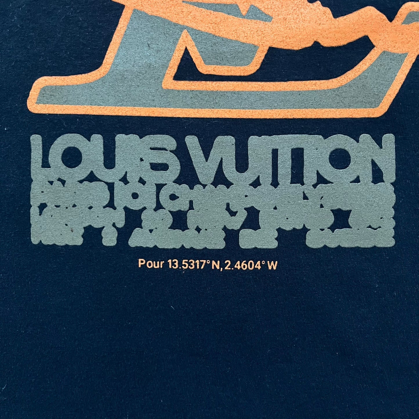 The Slawn LV Black Tee, given away at the Paris Pop-up in 2024, features a orange-brown LV logo on the front. Despite the branding, this is a Slawn creation, not an official Louis Vuitton piece.