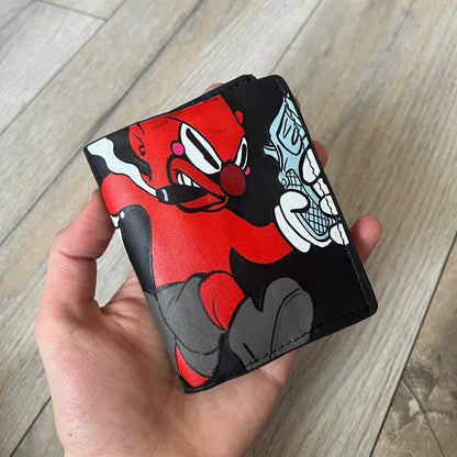 Slawn Leather Chain Man Wallet is a black foldable leather wallet featuring original artwork by Slawn on the front, depicting a red running figure holding a revolver and smoking a cigar. The wallet includes an attached metal chain for securing to clothing, along with eight card compartments and one top compartment for cash.