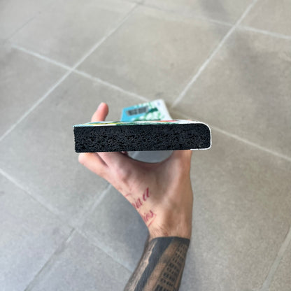 South Park 1998 Keyboard Wrist Rest is a thick foam wrist rest featuring the iconic bus stop scene with Cartman, Kenny, Stan, and Kyle kicking Ike. The design includes the wooden South Park sign and a small 1998 Comedy Central licensing mark, with a black base.
