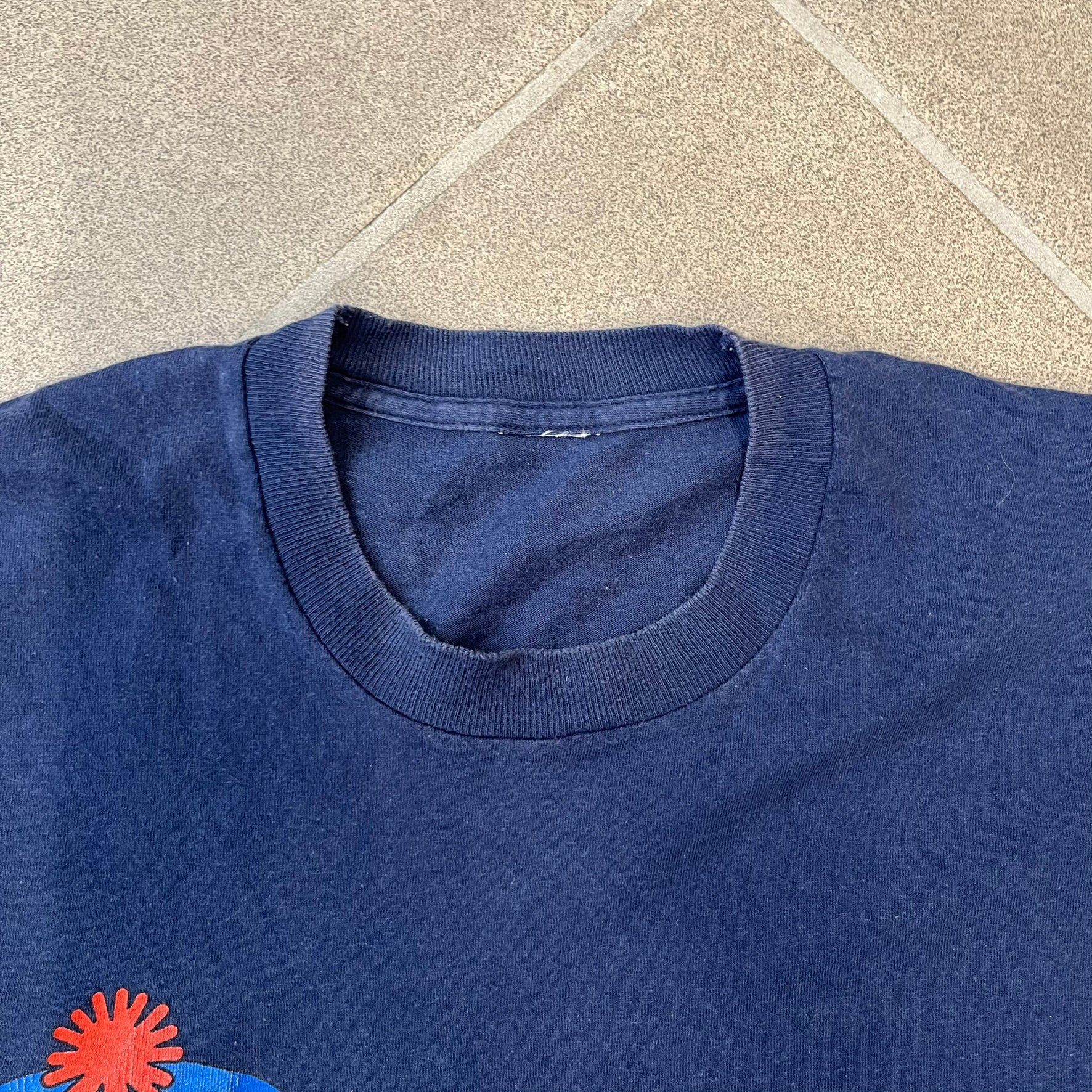 South Park 1998 “They Killed Kenny” Navy Tee features a a front graphic of Stan standing with a surprised expression next to a fallen Kenny. Below the characters is white “Oh My God! They Killed Kenny!” text, with a small South Park logo and 1998 licensing detail printed underneath on the right side. Made from cotton.