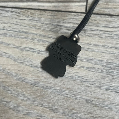 South Park 2000 Kyle Necklace features a black cord necklace with a metal pendant shaped as Kyle from South Park. The back of the pendant is marked with 2000 Comedy Central and Sedesma licensing details.