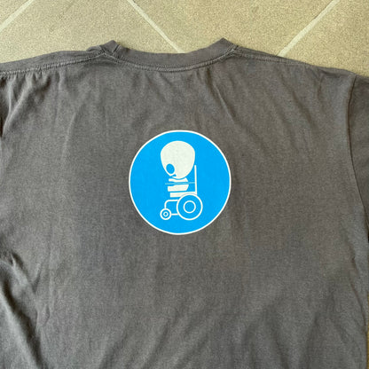 South Park 2008 Timmy “I’m Special” Tee features a grey T-shirt with a front graphic of Timmy’s face above a blue bar with white “I’m Special” text. Small 2008 licensing and Comedy Central details are printed underneath. The back features a blue and white wheelchair-accessibility sign graphic. Includes a licensed South Park neck tag.
