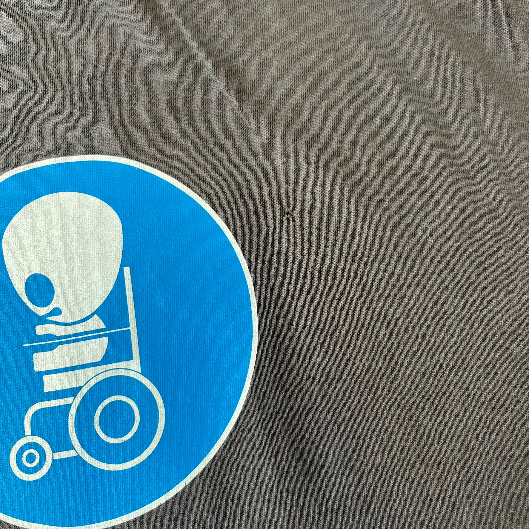 South Park 2008 Timmy “I’m Special” Tee features a grey T-shirt with a front graphic of Timmy’s face above a blue bar with white “I’m Special” text. Small 2008 licensing and Comedy Central details are printed underneath. The back features a blue and white wheelchair-accessibility sign graphic. Includes a licensed South Park neck tag.
