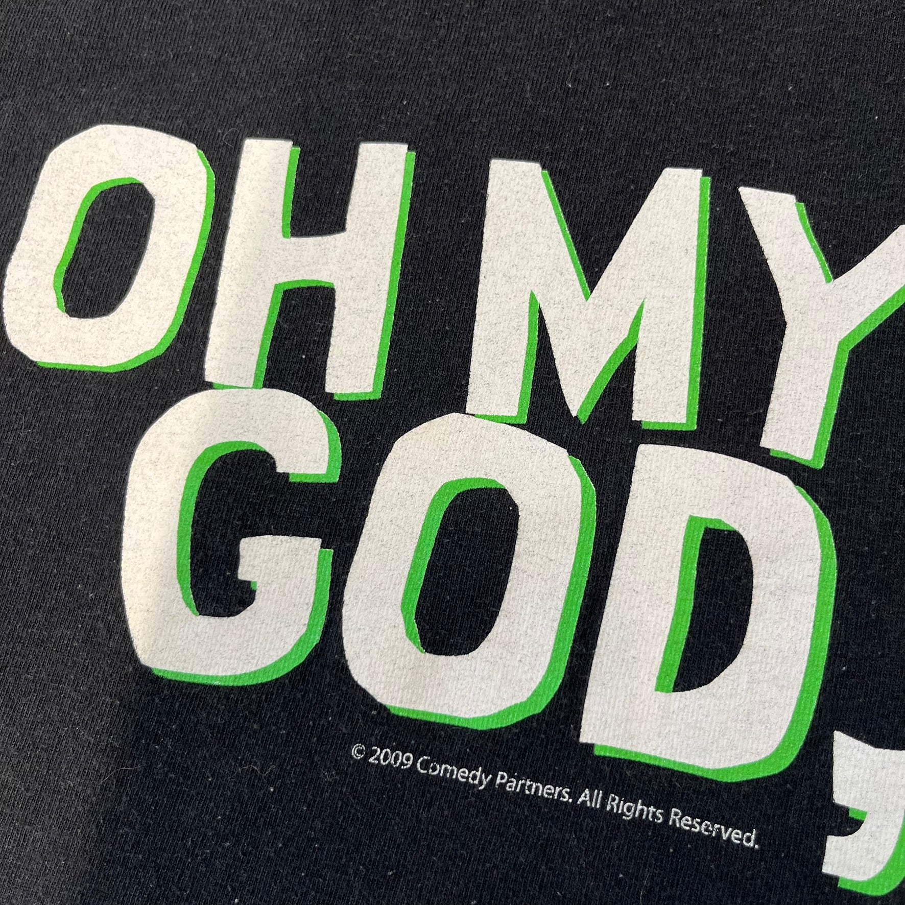 South Park 2009 “Oh My God, They Killed Kenny!” Tee is a black T-shirt made on a Fruit of the Loom blank. The front features a large graphic of Kyle with “Oh My God,” printed above and 2009 South Park licensing below. The back shows a stitched version of Kenny with “They Killed Kenny!” printed above the graphic.
