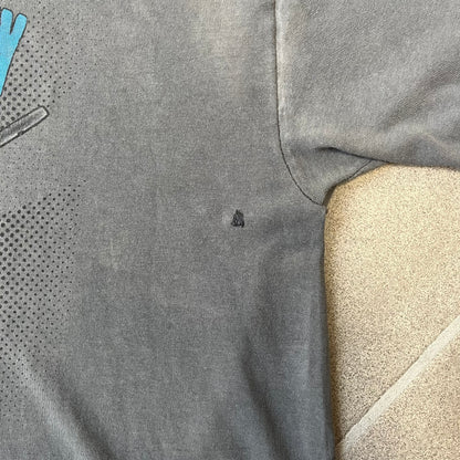 South Park 2009 “Respect My Authority” Gray Tee features a grey T-shirt with a front graphic of Cartman wearing a police uniform and running across a dotted cartoon-style background. Above the graphic is white and blue “Respect My Authority” text. The shirt has a South Park 2009 licensed neck tag and a heavily worn, distressed condition.
