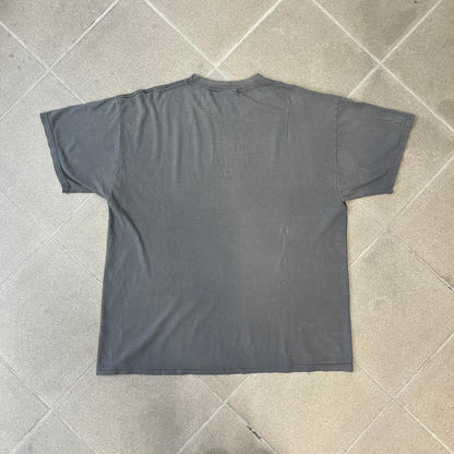 South Park 2009 “Respect My Authority” Gray Tee features a grey T-shirt with a front graphic of Cartman wearing a police uniform and running across a dotted cartoon-style background. Above the graphic is white and blue “Respect My Authority” text. The shirt has a South Park 2009 licensed neck tag and a heavily worn, distressed condition.
