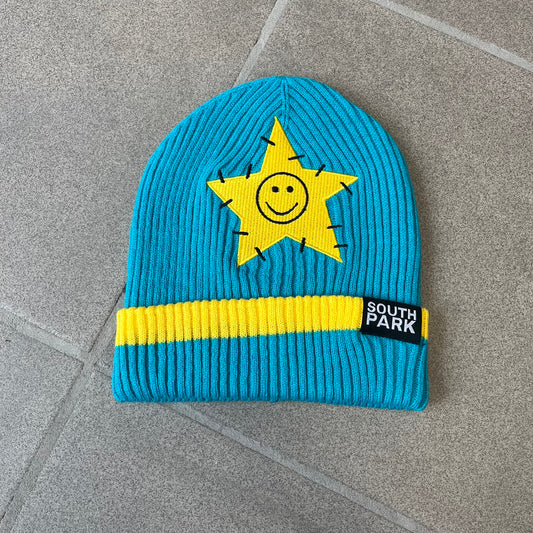 Exclusive South Park Snow Day Collector’s Edition Grand Wizard Cartman Beanie. Teal knit with yellow stripe detailing, embroidered yellow star with stitched effect, and official South Park branding tag. Made from a soft, stretchy material for a comfortable fit.