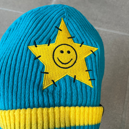 Exclusive South Park Snow Day Collector’s Edition Grand Wizard Cartman Beanie. Teal knit with yellow stripe detailing, embroidered yellow star with stitched effect, and official South Park branding tag. Made from a soft, stretchy material for a comfortable fit.