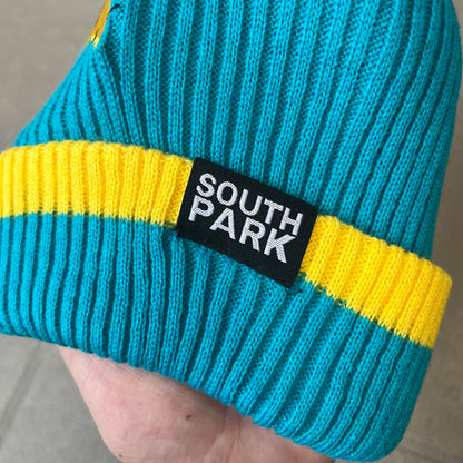 Exclusive South Park Snow Day Collector’s Edition Grand Wizard Cartman Beanie. Teal knit with yellow stripe detailing, embroidered yellow star with stitched effect, and official South Park branding tag. Made from a soft, stretchy material for a comfortable fit.