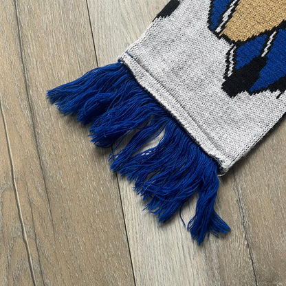Vintage football scarf in white and black with blue fringe / tassels, featuring South Park characters including Kenny, Cartman, and Kyle dressed in Chelsea kits. The character graphics appear on both sides of the scarf, with consistent coloring in blue. Soft knit construction with a classic football scarf shape and finish.