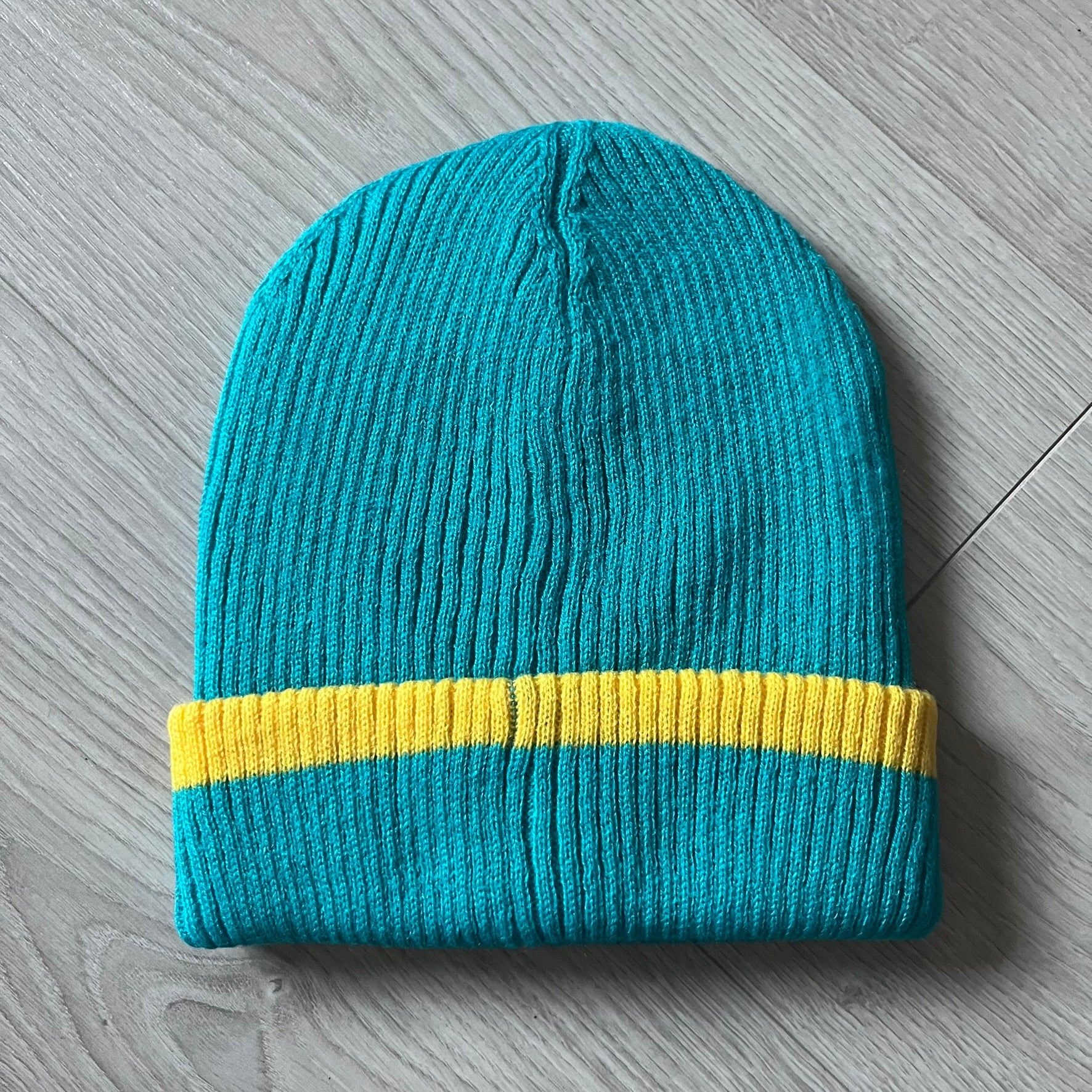 Exclusive South Park Snow Day Collector’s Edition Grand Wizard Cartman Beanie. Teal knit with yellow stripe detailing, embroidered yellow star with stitched effect, and official South Park branding tag. Made from a soft, stretchy material for a comfortable fit.