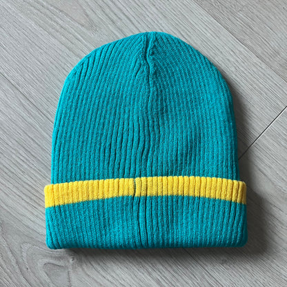 Exclusive South Park Snow Day Collector’s Edition Grand Wizard Cartman Beanie. Teal knit with yellow stripe detailing, embroidered yellow star with stitched effect, and official South Park branding tag. Made from a soft, stretchy material for a comfortable fit.