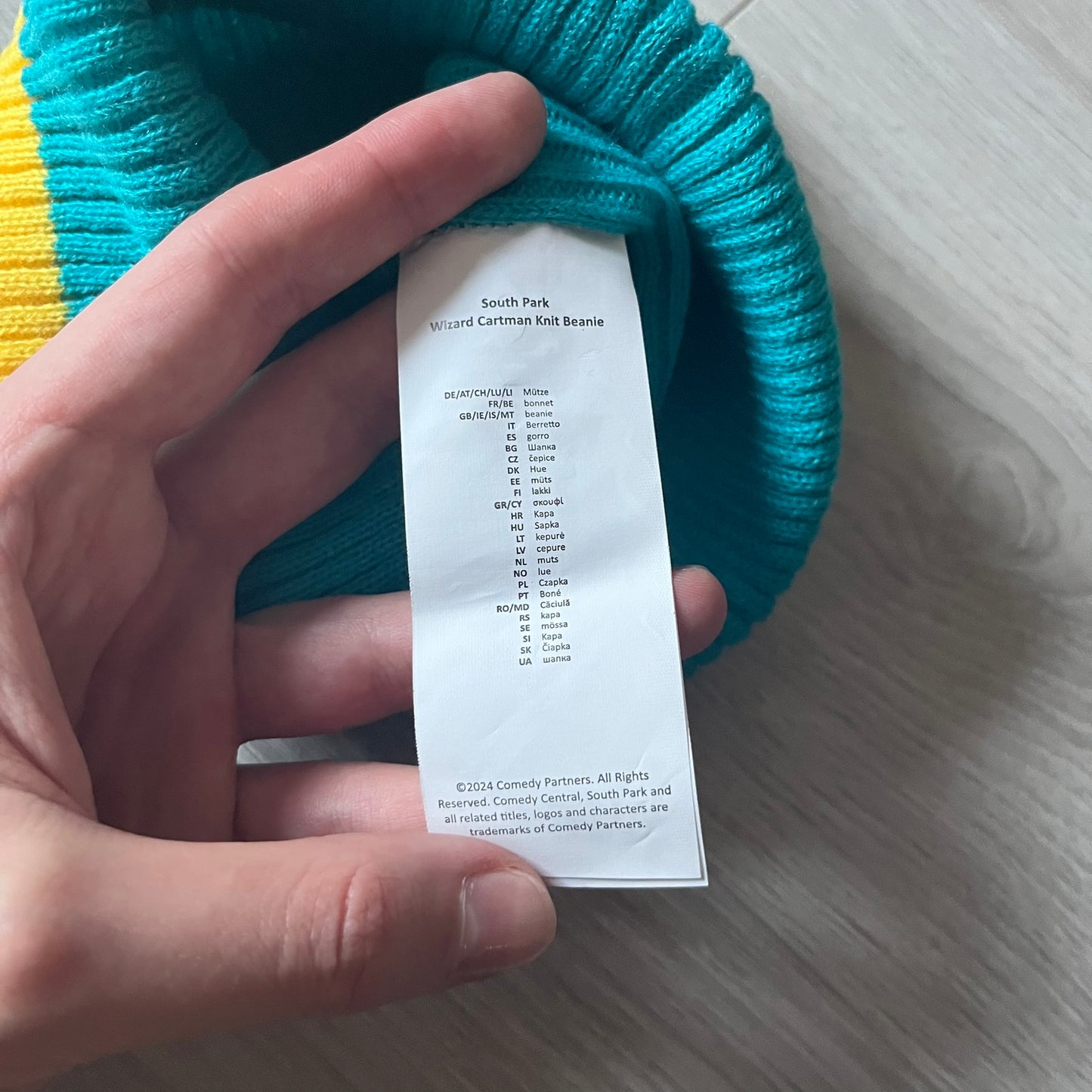 Exclusive South Park Snow Day Collector’s Edition Grand Wizard Cartman Beanie. Teal knit with yellow stripe detailing, embroidered yellow star with stitched effect, and official South Park branding tag. Made from a soft, stretchy material for a comfortable fit.