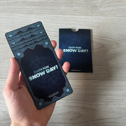 Set of 6 South Park Snow Day tarot cards, exclusive to the Collector’s Edition. Features characters like the Emo Kids with designs such as “Prince of Ravens” and “Non-Conformist.” Each card has dark red and black front artwork with a blue South Park Snow Day back.