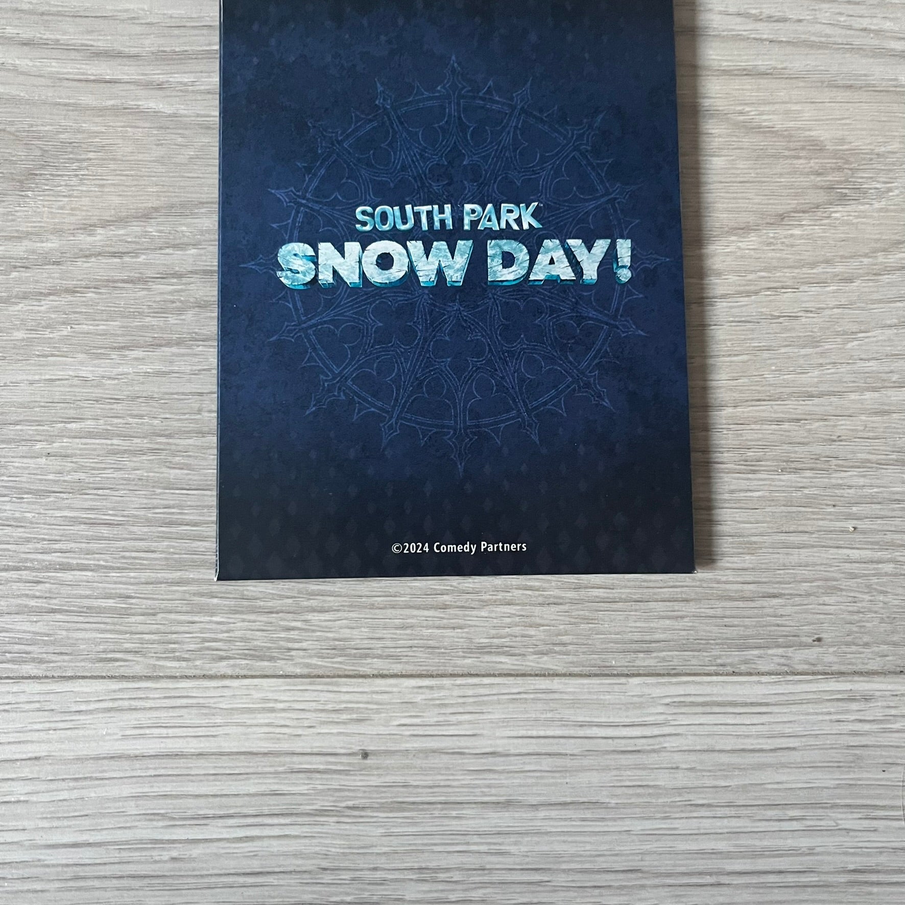 Set of 6 South Park Snow Day tarot cards, exclusive to the Collector’s Edition. Features characters like the Emo Kids with designs such as “Prince of Ravens” and “Non-Conformist.” Each card has dark red and black front artwork with a blue South Park Snow Day back.