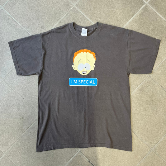 South Park 2008 Timmy “I’m Special” Tee features a grey T-shirt with a front graphic of Timmy’s face above a blue bar with white “I’m Special” text. The back features a blue and white wheelchair-accessibility sign graphic and 4 main characters white outlines with small 2008 licensing and Comedy Central details printed underneath.