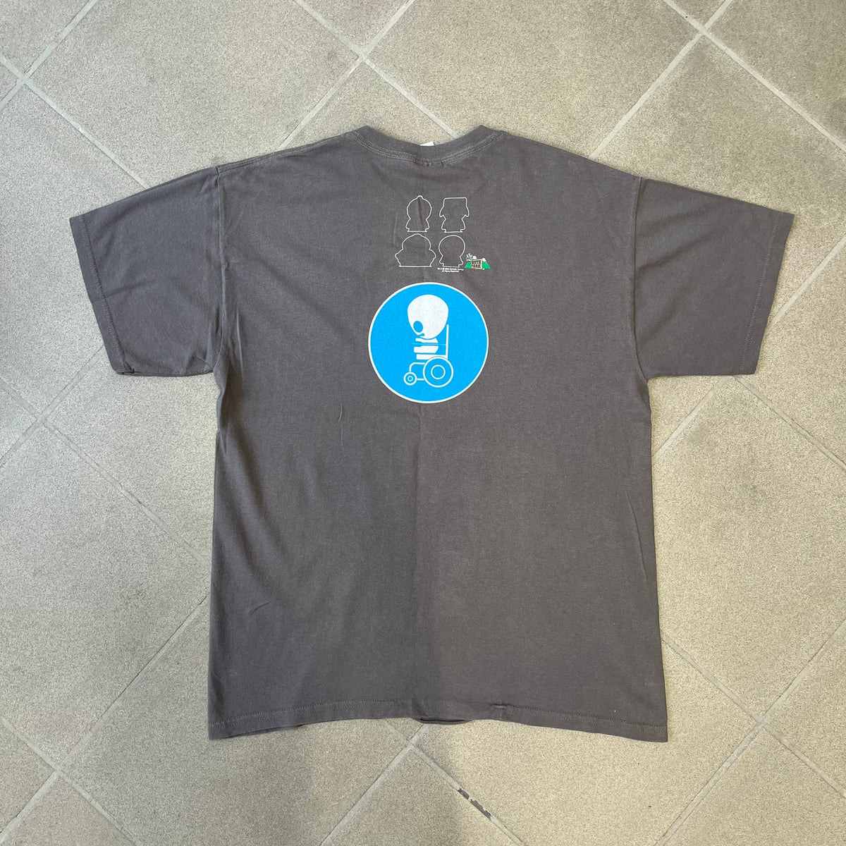South Park 2008 Timmy “I’m Special” Tee features a grey T-shirt with a front graphic of Timmy’s face above a blue bar with white “I’m Special” text. The back features a blue and white wheelchair-accessibility sign graphic and 4 main characters white outlines with small 2008 licensing and Comedy Central details printed underneath.