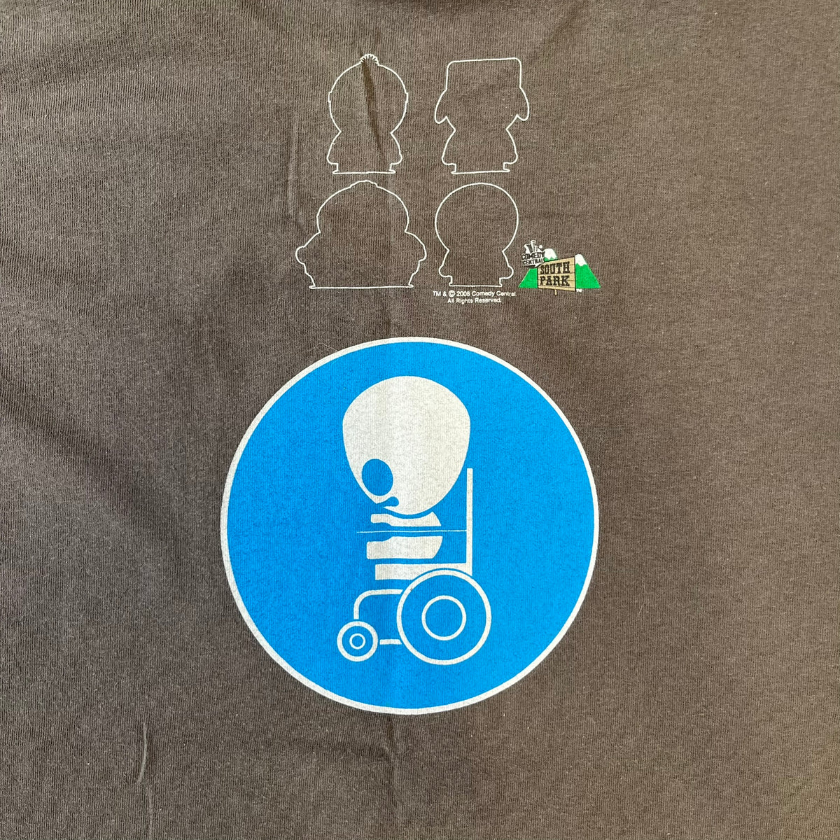 South Park 2008 Timmy “I’m Special” Tee features a grey T-shirt with a front graphic of Timmy’s face above a blue bar with white “I’m Special” text. The back features a blue and white wheelchair-accessibility sign graphic and 4 main characters white outlines with small 2008 licensing and Comedy Central details printed underneath.