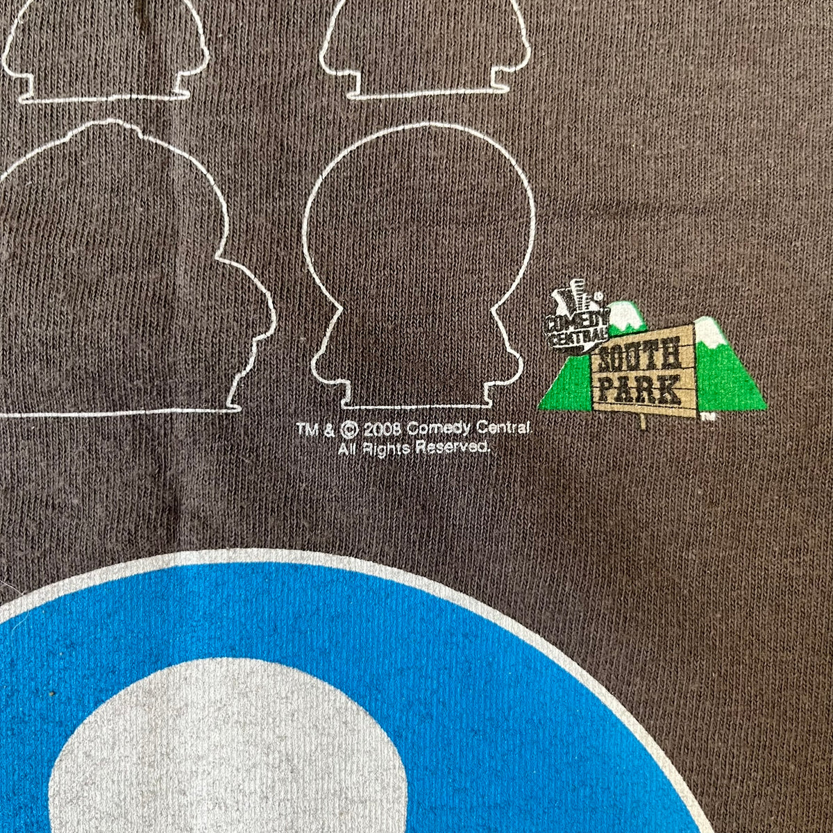 South Park 2008 Timmy “I’m Special” Tee features a grey T-shirt with a front graphic of Timmy’s face above a blue bar with white “I’m Special” text. The back features a blue and white wheelchair-accessibility sign graphic and 4 main characters white outlines with small 2008 licensing and Comedy Central details printed underneath.